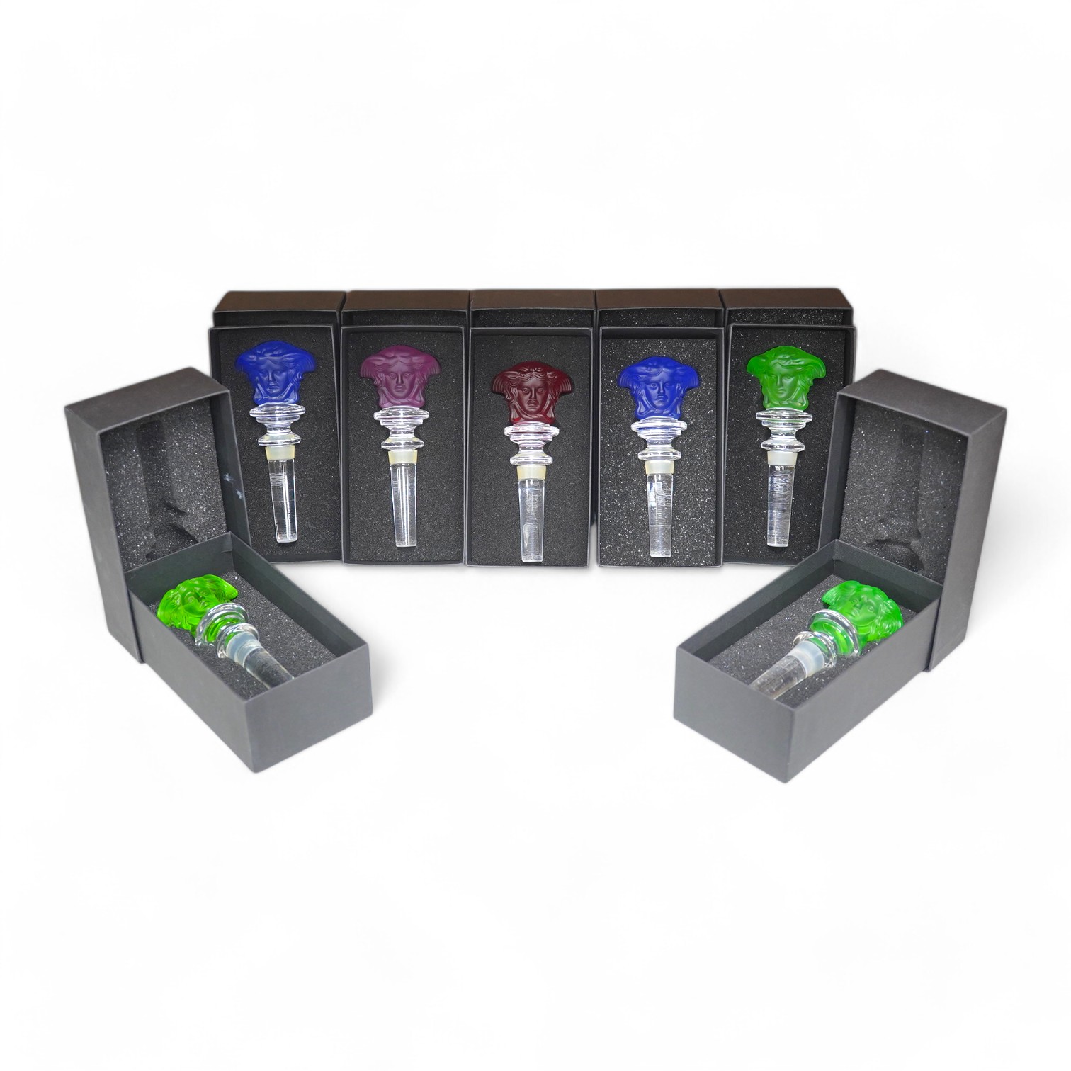 Seven boxed Rosenthal for Versace glass Medusa head wine bottle stoppers in various colours. Condition - good.